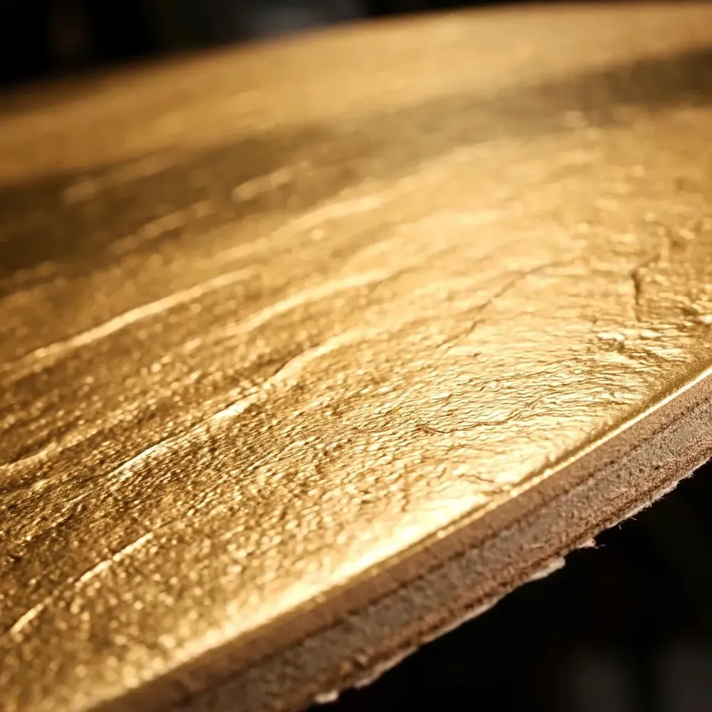 Macro of a gold metallized cake board surface and edge